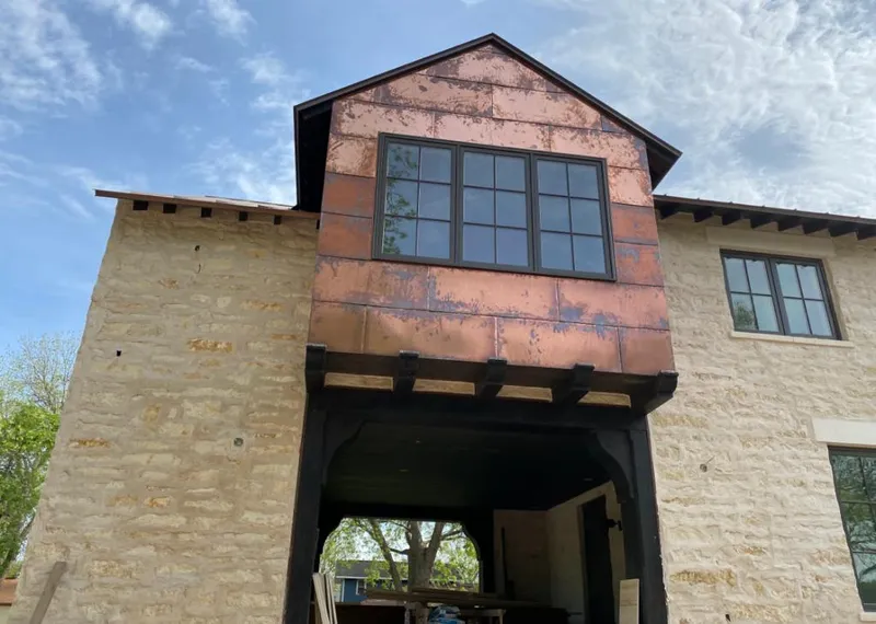 Copper metal panel facade on a stone building for Skylight Installation in Glen Ellyn