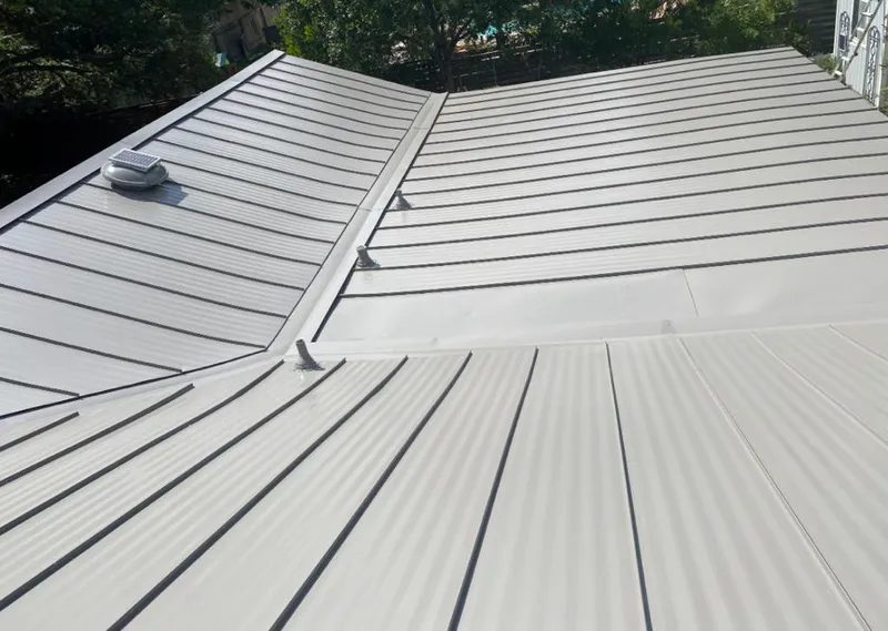 Solar attic fan installed on a metal roof for Roof Ventilation in Glen Ellyn